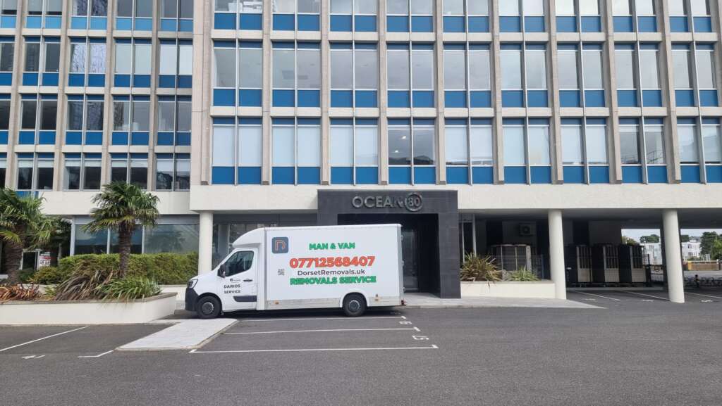 Dorset Removals specialist van parked outside a commercial office building in Bournemouth ready for a business relocation.
